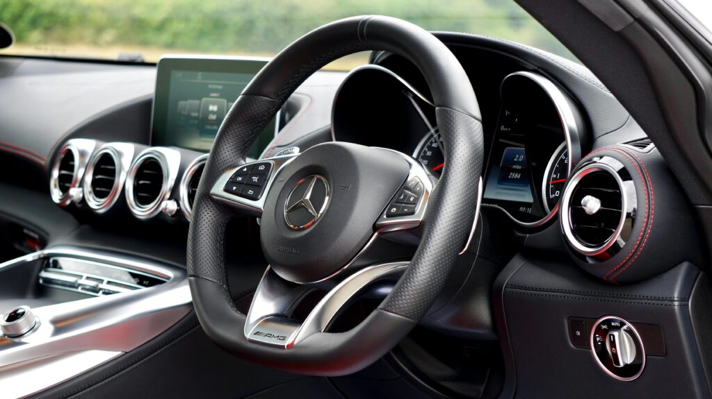 Interior view of a luxury Mercedes-Benz car showcasing the steering wheel and dashboard.